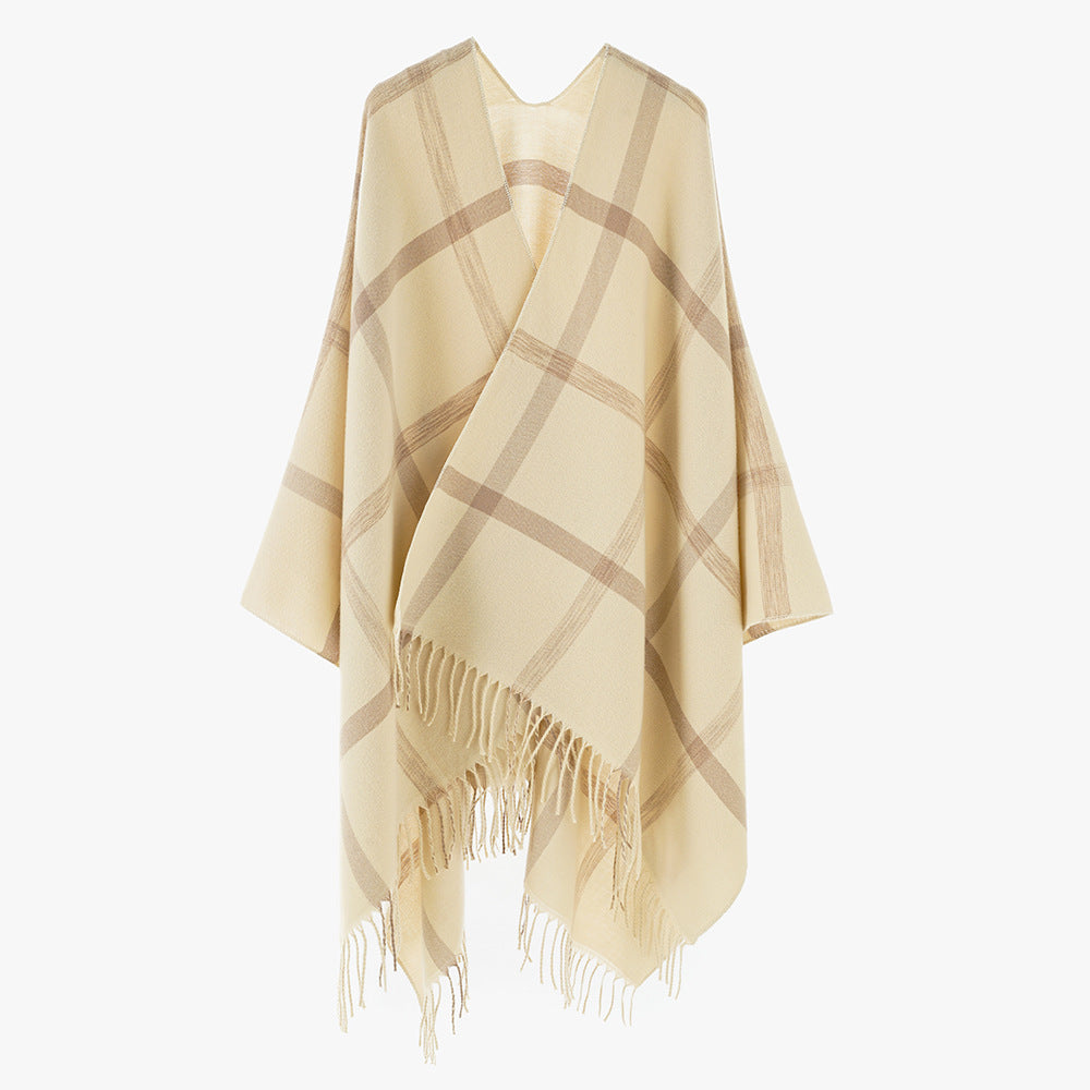 Women's large checkered wool look poncho in cape cut with loose drape and fringes.