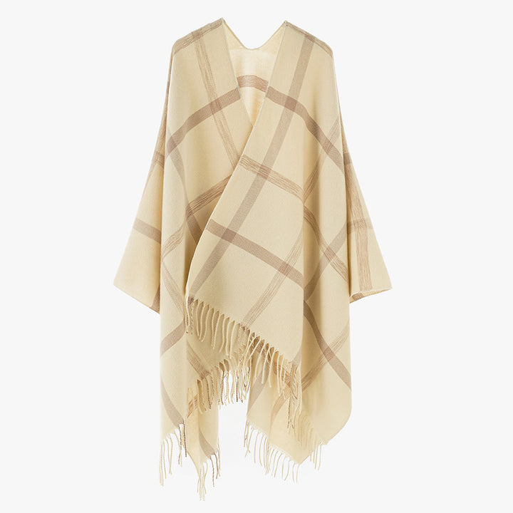 Women's large checkered wool look poncho in cape cut with loose drape and fringes.