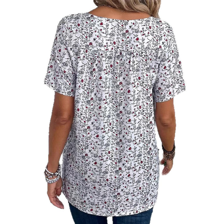 Ladies casual short-sleeve tunic shirt with round neckline, delicate all-over floral print and decorative chest pleats Mune Fashion