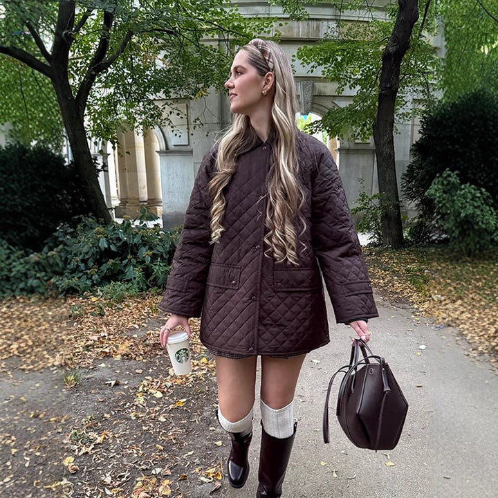 Women's oversized quilted jacket in coat style with snap button placket and patch flap pockets Mune Fashion