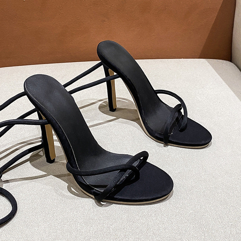 Women's ankle strap sandals with twisted lace straps, slim stiletto heel, and padded comfort footbed Mune Fashion