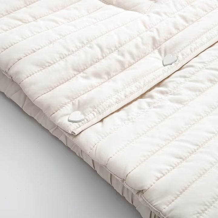 Women's short quilted jacket with vertical quilting, shirt collar and heart button placket Mune Fashion