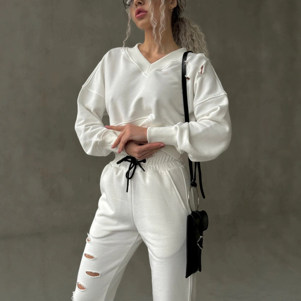 Ladies short-cut sweat set with V-neck, ruffled waistband high-waist joggers and distressed details Mune Fashion