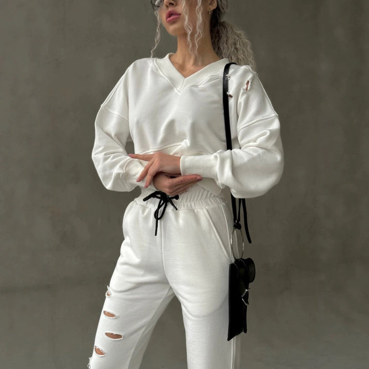 Ladies short-cut sweat set with V-neck, ruffled waistband high-waist joggers and distressed details Mune Fashion