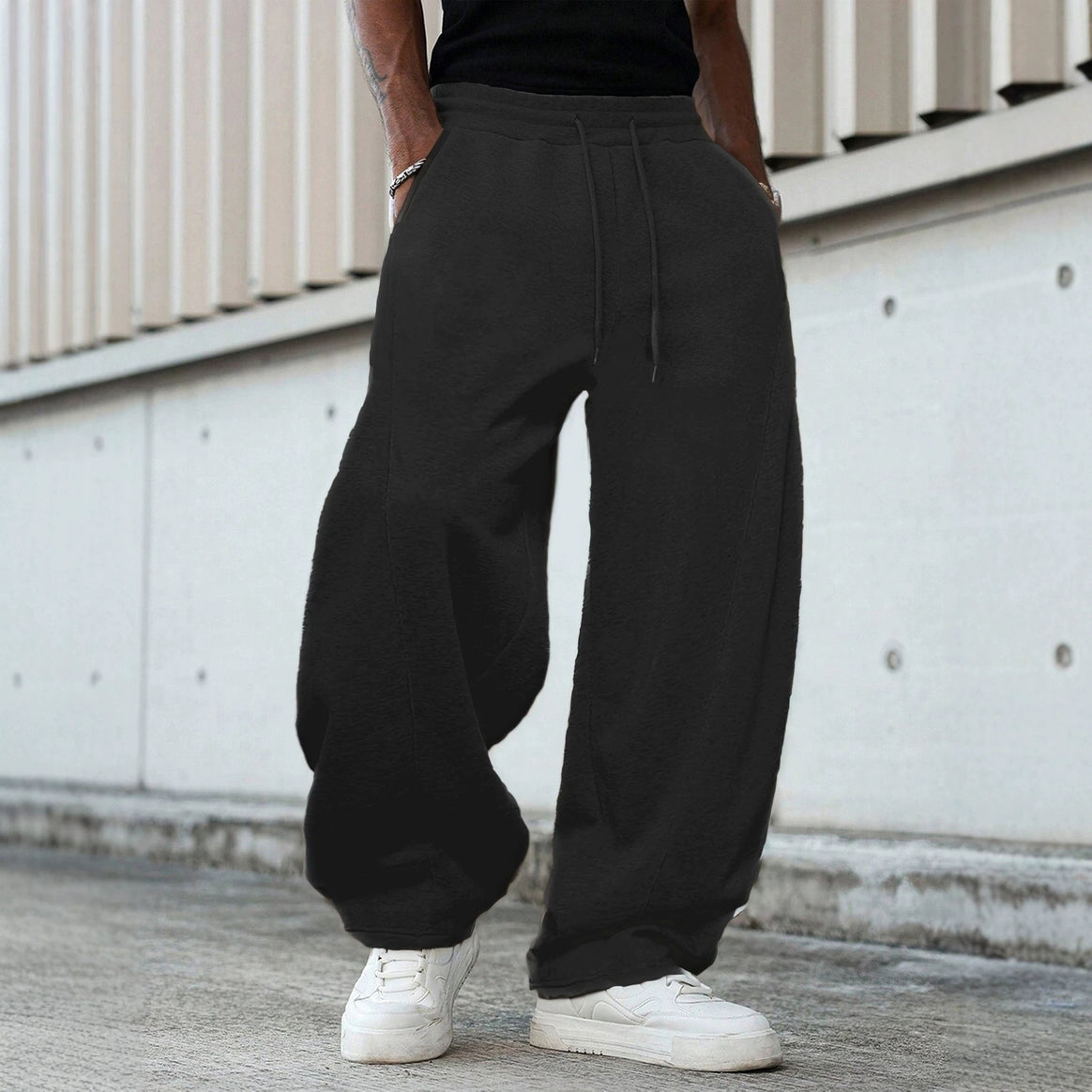 Men's loose sweatpants in baggy cut with elastic waistband, drawstring, and side pockets Mune Fashion
