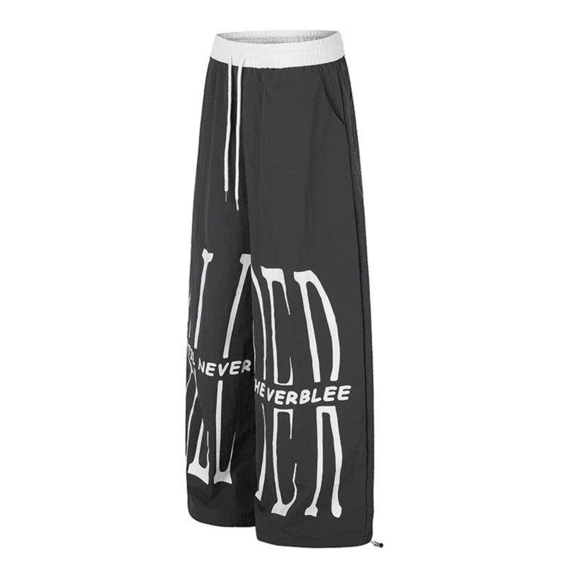 Women's wide loungewear pants with high comfort waistband, drawstring, adjustable hem, and typographic print Mune Fashion