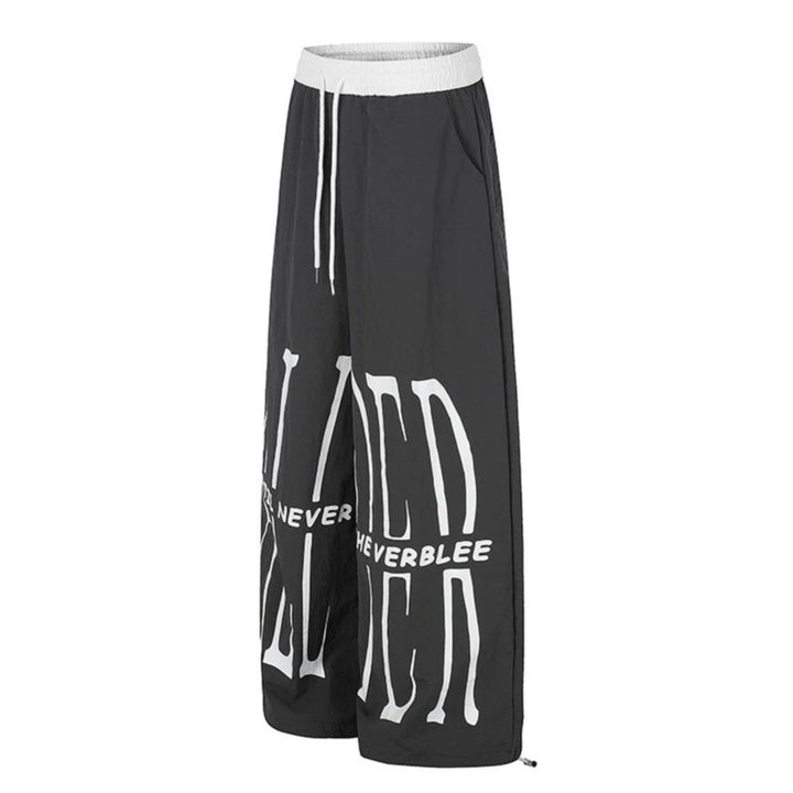 Women's wide loungewear pants with high comfort waistband, drawstring, adjustable hem, and typographic print Mune Fashion