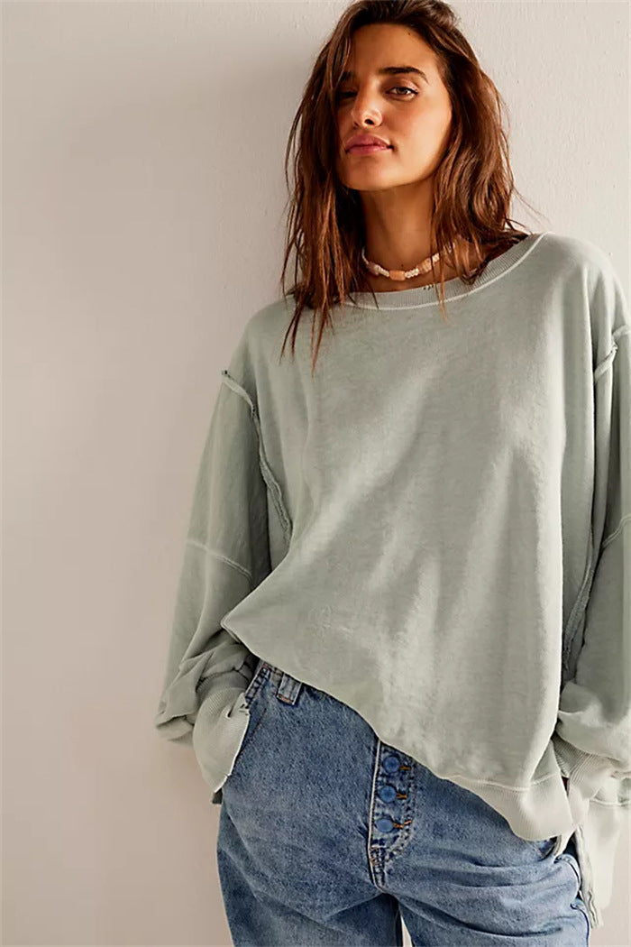 Women's oversized sweatshirt with balloon sleeves, open seam stitches, and side slits Mune Fashion