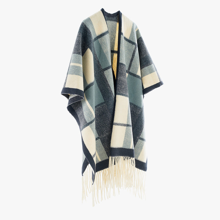 Women's cape poncho in oversized rectangular cut with checkered weave structure and fringes.