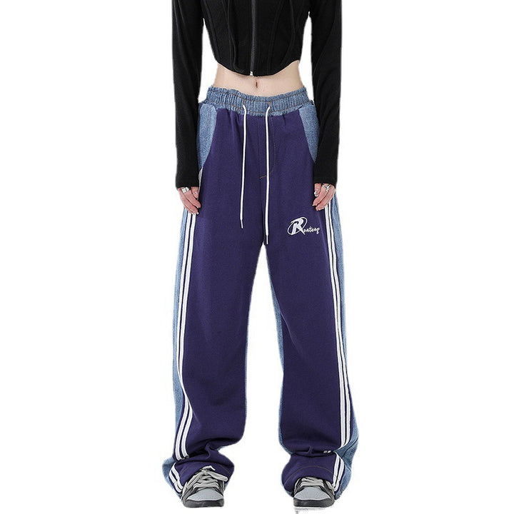 Ladies loose-fitting jogging pants with denim inserts, elastic waistband, and side contrast stripes Mune Fashion