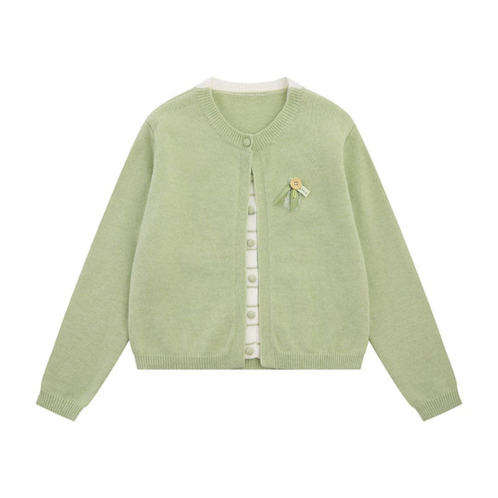 Ladies fine knit cardigan with round neckline, concealed button placket, and decorative brooch Mune Fashion