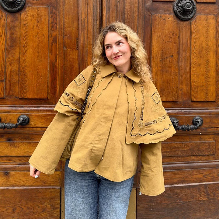 Women's short jacket with embroidered cape, eyelet embroidery and curved hem Mune Fashion