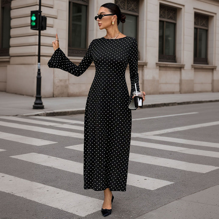 Women's elegant polka-dot maxi dress with fitted bodice, trumpet sleeves, and flowing A-line skirt.