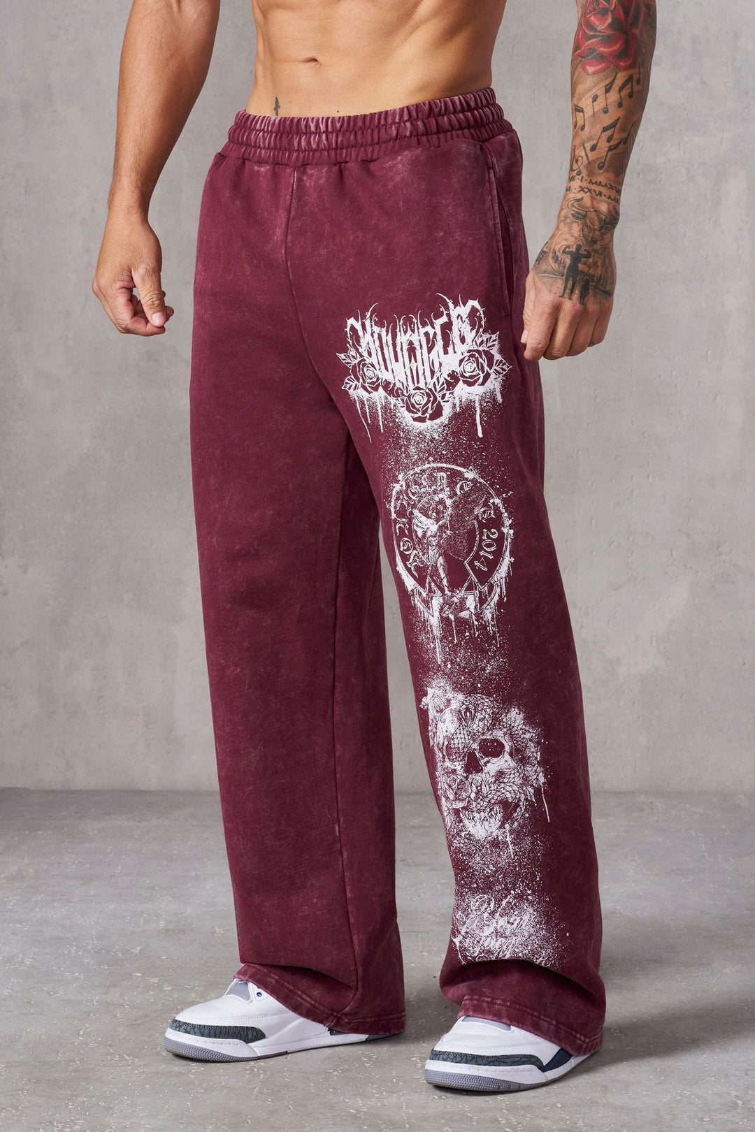 Men's baggy joggers with elastic waistband, side pockets and detailed skull and rose motif Mune Fashion