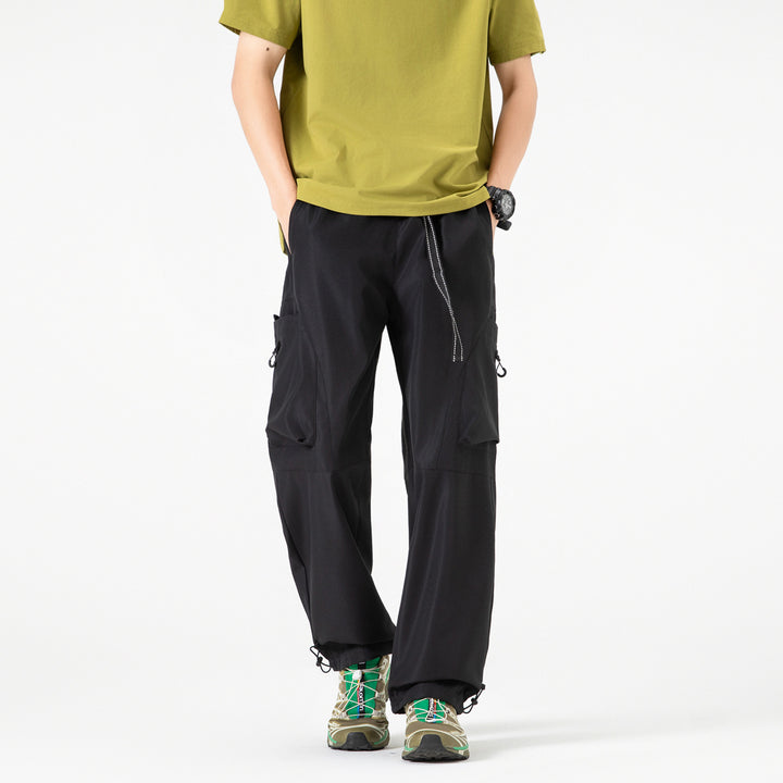 Men's wide cargo pants in baggy style with drawstring waistband, large flap pockets, and adjustable leg openings Drune