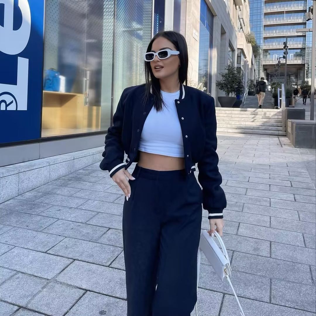 Women nan short college bomber jacket with snap button closure, ribbed stripe waistband and side pockets Mune Fashion
