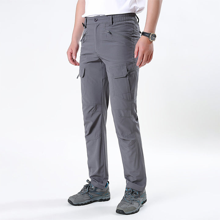 Men's nano technical trekking pants with elastic waistband, pre-shaped knees, and multiple cargo and zip pockets.