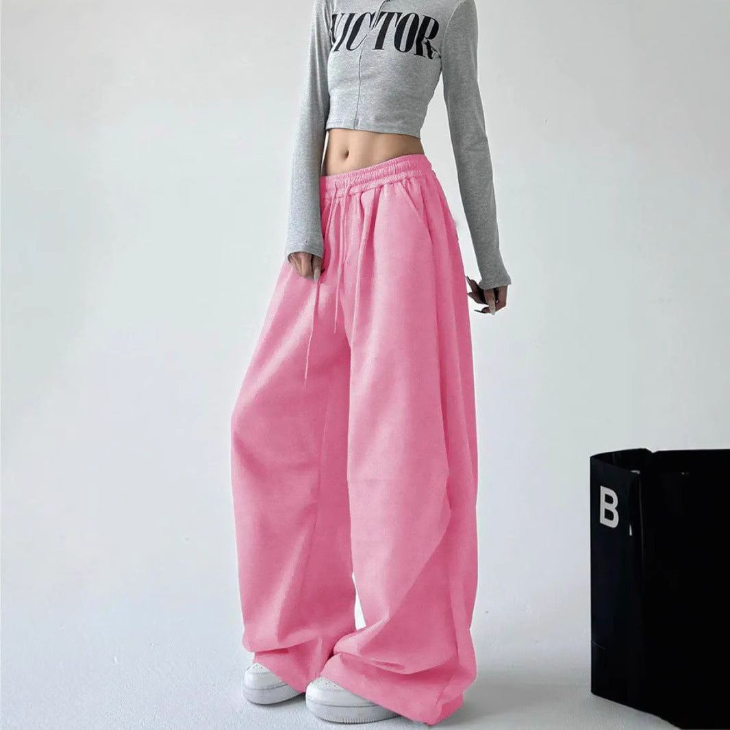 Women's loose-fitting high-waist lounge pants with elastic waistband, drawstring, and side pockets.