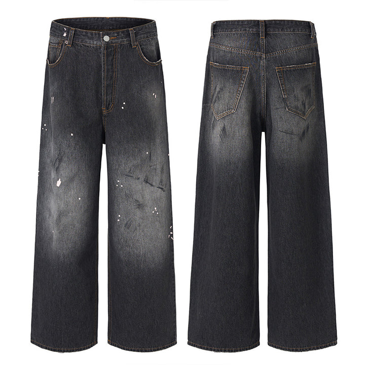 Men's loosely cut denim pants in floor-length baggy style with subtle paint splatter look Mune Fashion