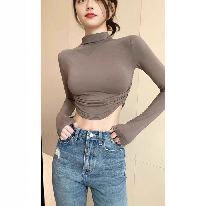 Ladies form-fitting long sleeve cropped top with stand-up collar, side gathering and extended sleeves Mune Fashion