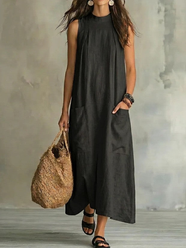 Women’s sleeveless linen maxi dress with standing collar, pleats at the chest, and piled pockets Mune Fashion