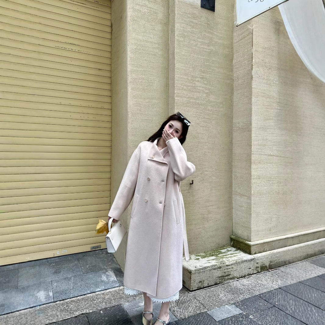 Women’s wool coat with double-breasted button placket, waist belt, and stand-up collar Mune Fashion