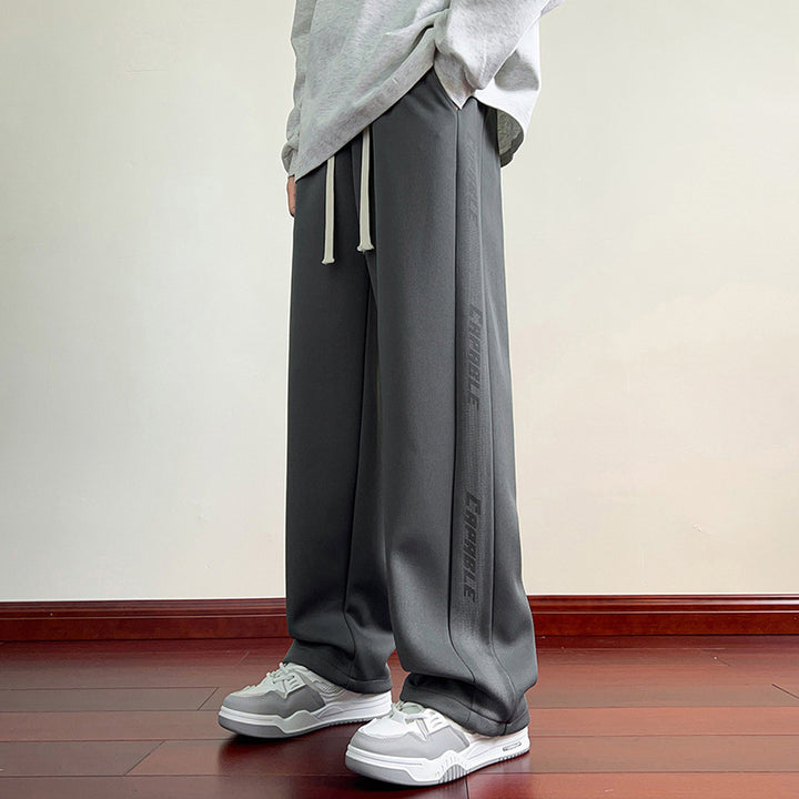 Men's sporty leisure pants with elastic waistband and side graphics