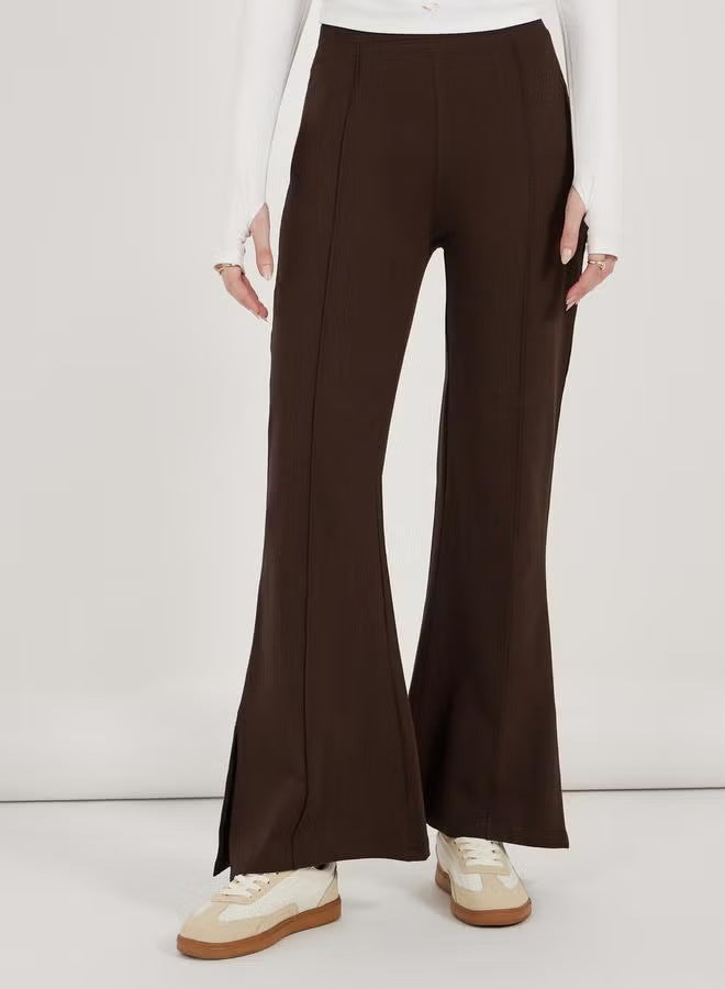 Women’s flared pants with high waist, continuous crease and side hem slit Drune