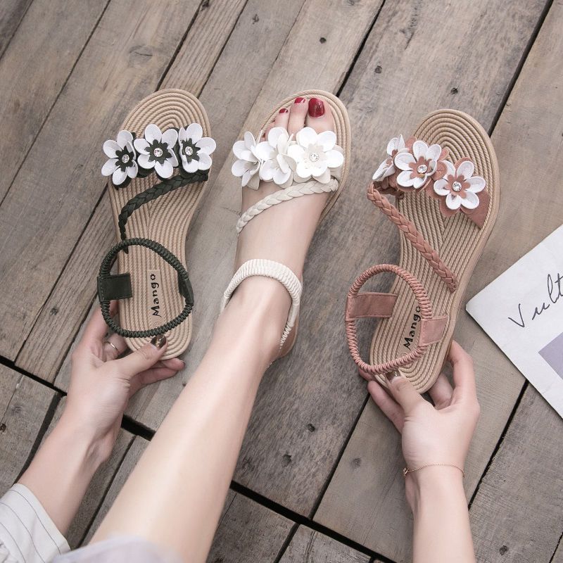 Women's playful strap sandal with braided decorative bands, flower appliqués, and elastic heel strap Mune Fashion