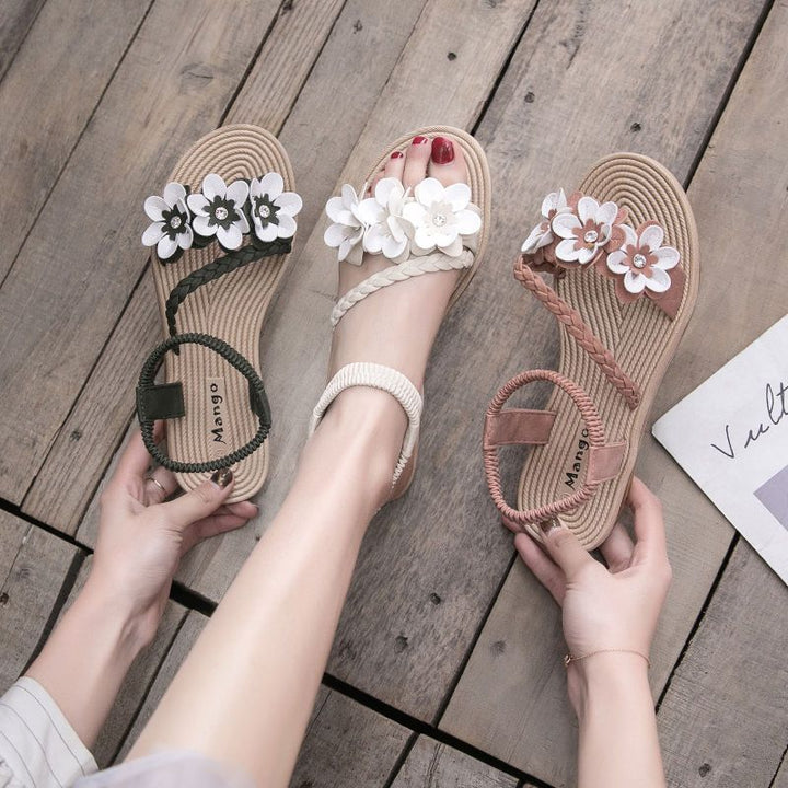 Women's playful strap sandal with braided decorative bands, flower appliqués, and elastic heel strap Mune Fashion