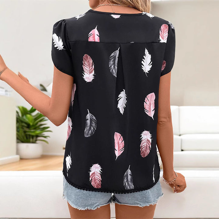 Women's short blouse in lightweight viscose look with feather motif, V-neck, decorative button placket, and puff sleeves Mune Fashion