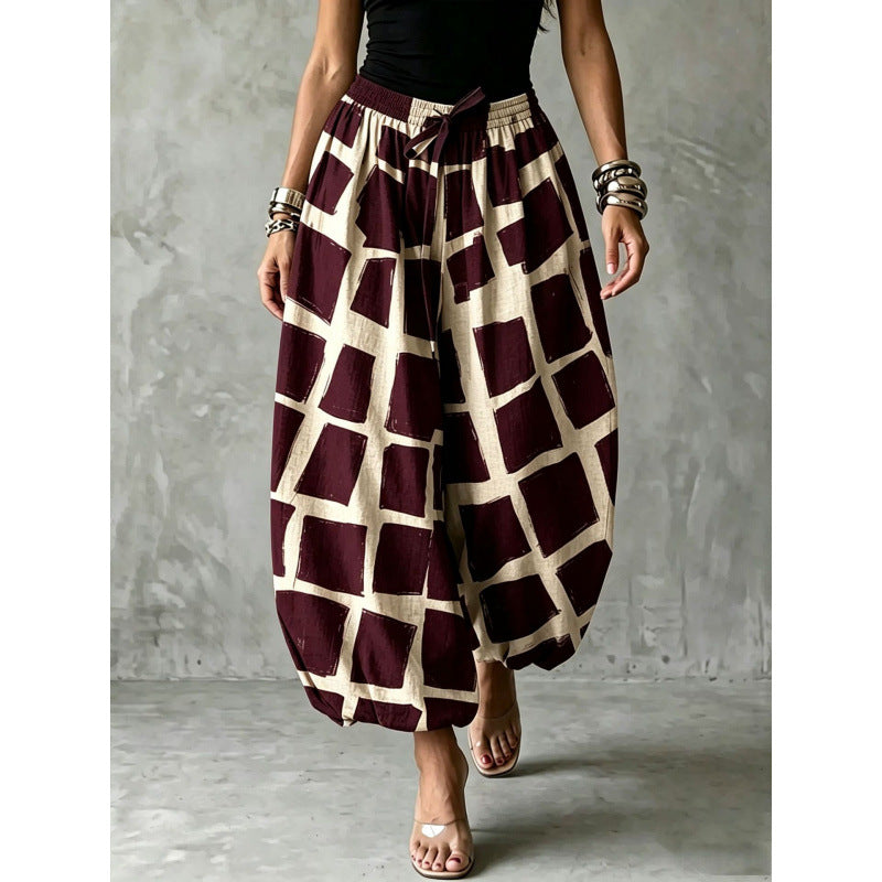 Women's wide harem pants in balloon style with elastic waistband and graphic check pattern Mune Fashion