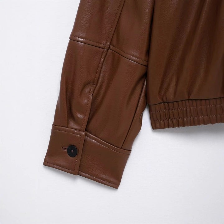 Women's cropped faux leather bomber jacket with shirt collar, concealed zipper, and elastic waistband Mune Fashion