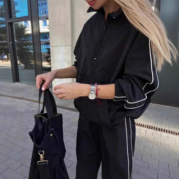 Women's lightweight half-zip windbreaker top with kangaroo pocket, elastic cuffs, and side piping Mune Fashion