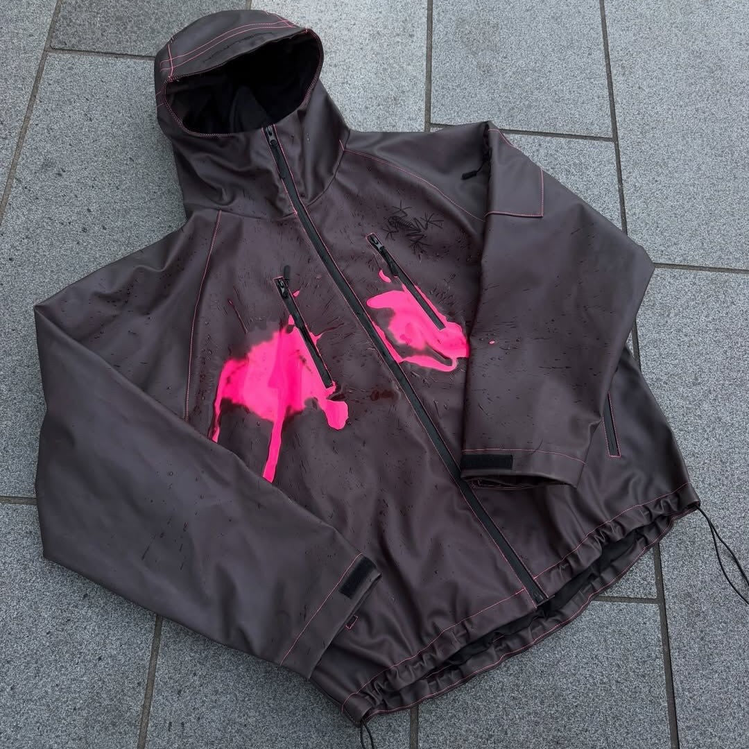 Unisex nan technical rain jacket with welded seams, slanted chest zip pockets, and adjustable drawstring hem Mune Fashion