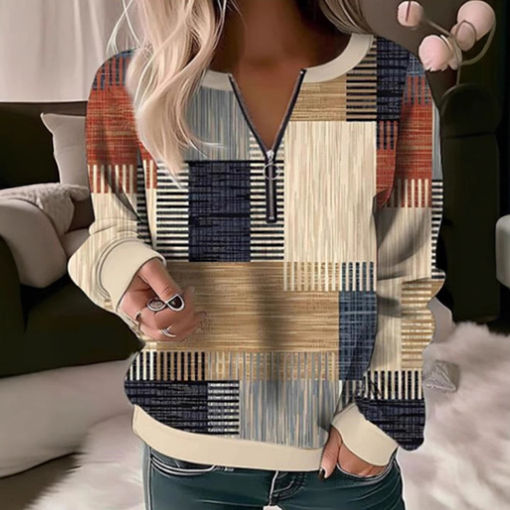 Women's cozy sweater with short zip, graphic patchwork pattern, extended sleeve cuffs, and ribbed hem Mune Fashion