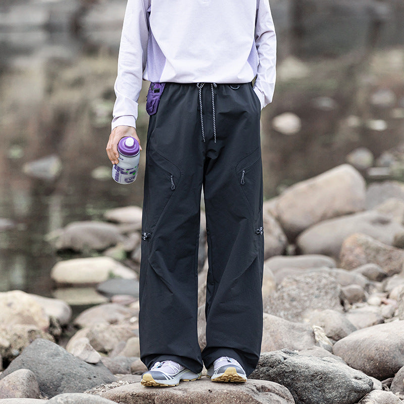 Men's loose technical cargo pants with drawstring, zipper pockets, and adjustable hem Mune Fashion