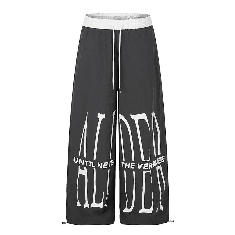 Women's wide loungewear pants with high comfort waistband, drawstring, adjustable hem, and typographic print Mune Fashion