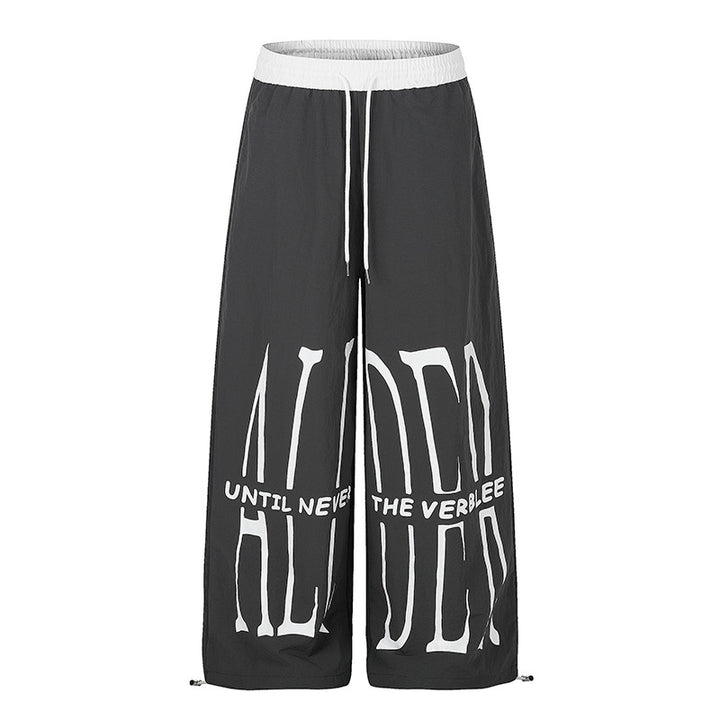 Women's wide loungewear pants with high comfort waistband, drawstring, adjustable hem, and typographic print Mune Fashion