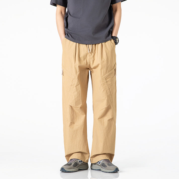 Men's loose-fitting nylon cargo pants with drawstring waistband and angled utility pockets Mune Fashion