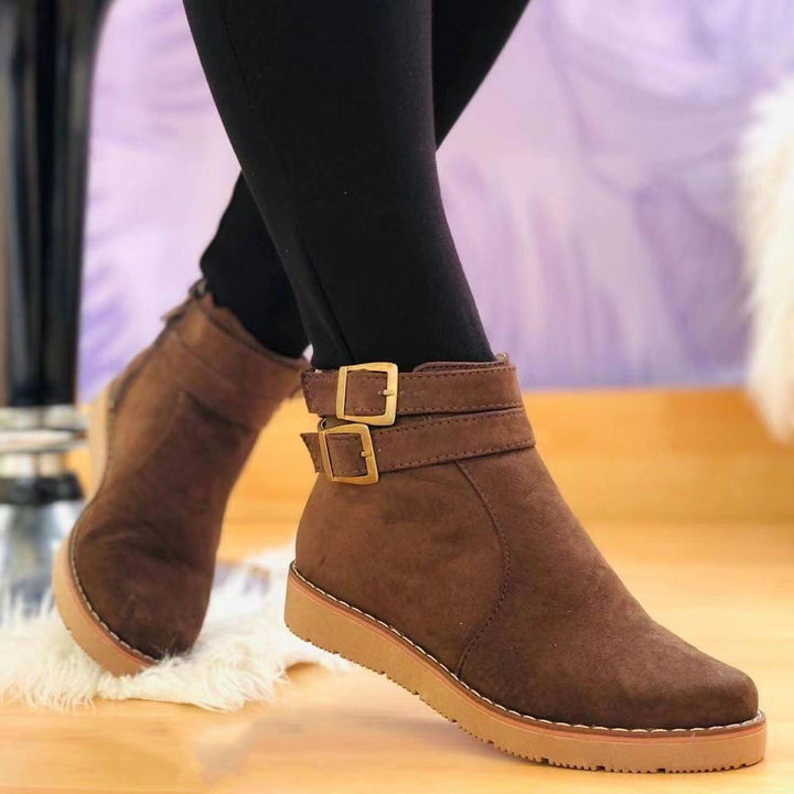 Women's faux suede ankle boot with double decorative buckle, side zipper, and slip-resistant profile sole Mune Fashion