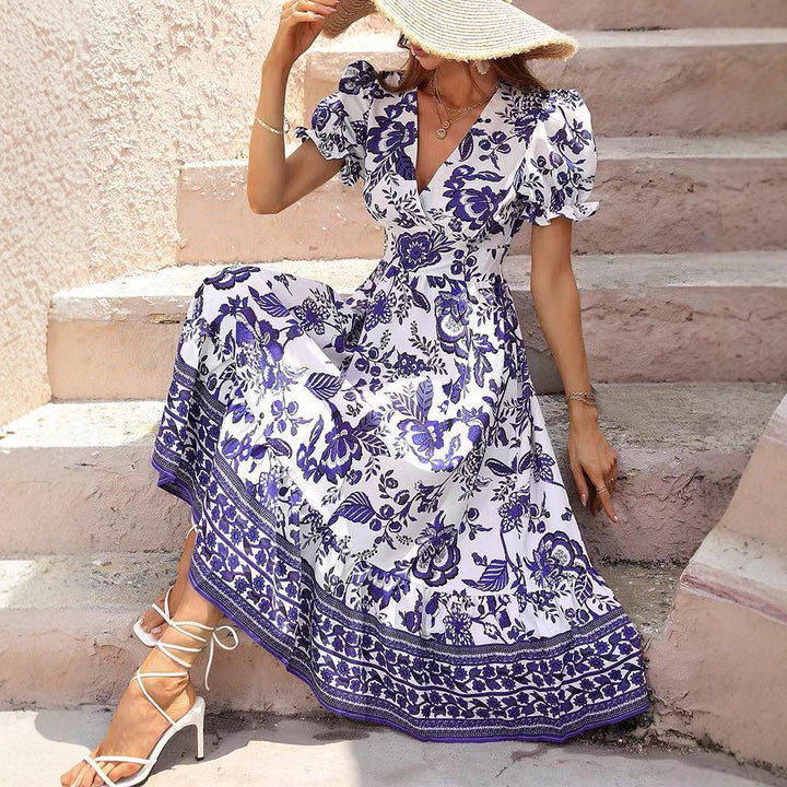 Women’s boho-inspired maxi dress with gathered empire waist, short puff sleeves, and decorative border print Mune Fashion