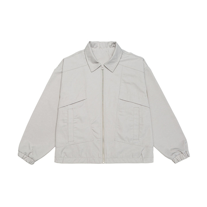 Unisex short jacket in boxy cut with shirt collar, visible metal zipper and utility patch pockets Mune Fashion