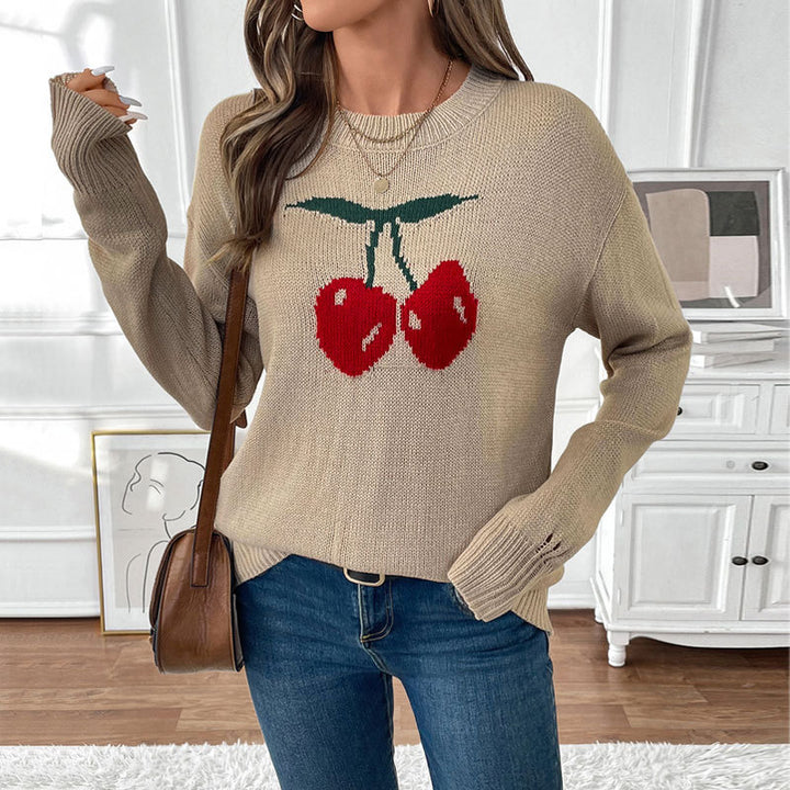 Women's oversized knit sweater with cherry intarsia, lightly distressed look and round neck.