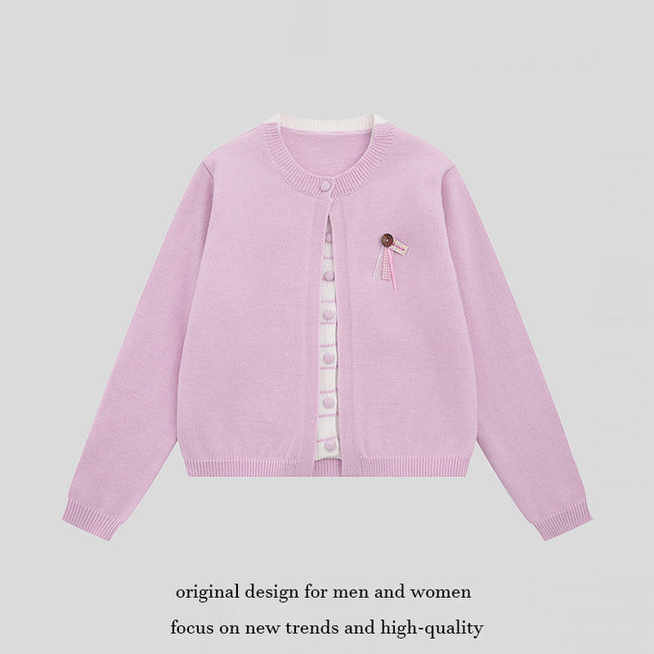 Ladies fine knit cardigan with round neckline, concealed button placket, and decorative brooch Mune Fashion