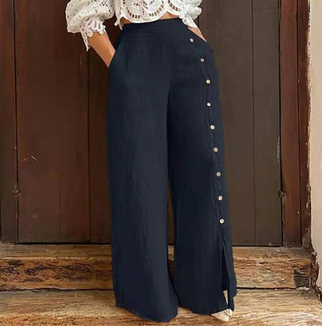 Women's high-waisted linen trousers with a side decorative button placket, side pockets, and wide leg cut Mune Fashion