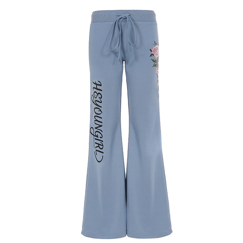 Women's casual jersey sweatpants with drawstring, floral side print, and statement lettering Mune Fashion