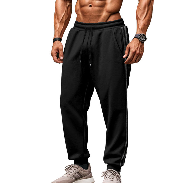 Men's sporty jogging pants with side contrast stripes, elastic drawstring waistband, and ribbed leg endings Mune Fashion