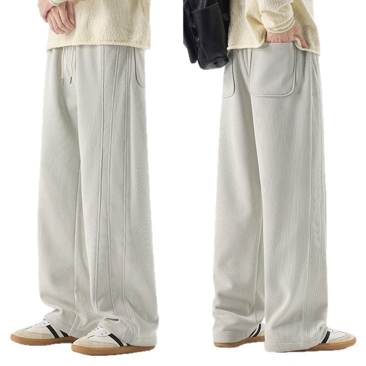 Men's loose sweatpants with decorative seam piping and drawstring