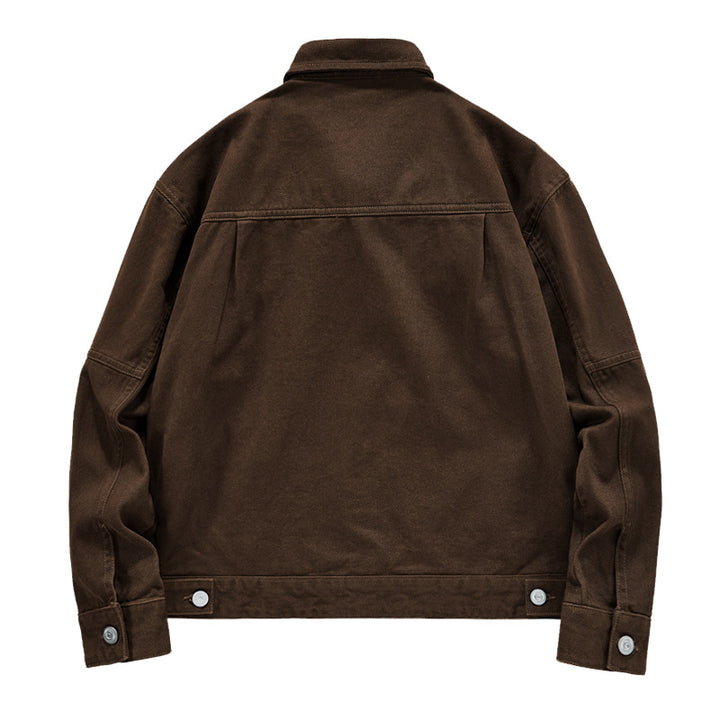 Men's short worker jacket made of heavy twill with applied flap pockets, slanted side pockets, and reinforced seams.
